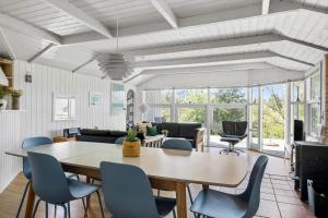 a dining room with a table and chairs at 0252-Romo-Kromosevej-6 in Høm