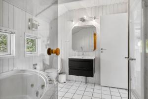 a white bathroom with a tub and a sink at 0252-Romo-Kromosevej-6 in Høm +31 photos