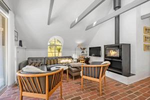 a living room with a couch and a fireplace at 0209-Romo-Vrabyvej-34 in Høm