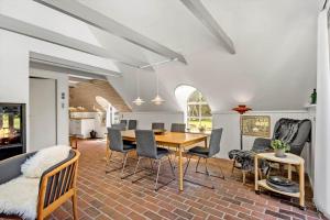 a dining room with a table and chairs at 0209-Romo-Vrabyvej-34 in Høm