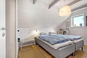 a bedroom with a large bed in a room at 0209-Romo-Vrabyvej-34 in Høm