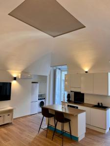a kitchen with white cabinets and a table and chairs at Hely's House in Naples