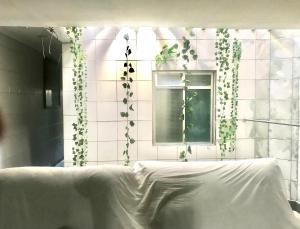 a bedroom with a white bed and a window at casa boa vista in Recife