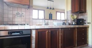 a kitchen with a sink and a stove top oven at Appartamento due camere Castellarano Sassuolo in Castellarano
