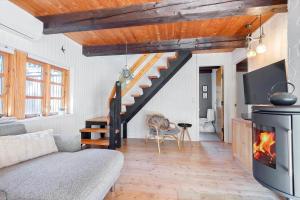 a living room with a staircase and a fireplace at 0310-Romo-Langdalsvej-61 in Høm