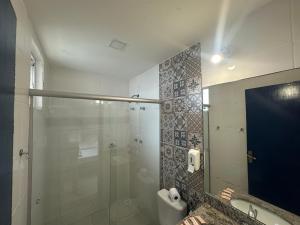 a bathroom with a glass shower and a toilet at Pousada Vila Catarina in Ouro Preto +15 photos