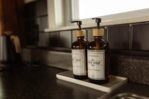 two bottles of alcohol sitting on a counter in a kitchen at Fawn Crest -Timber Frame Retreat, Firepit, 20 acre in Alfred Station +73 photos
