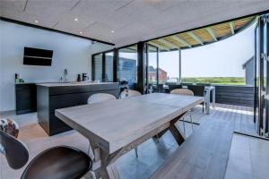 a kitchen and dining room with a table and chairs at 0374-Romo-Vestergade-337 in Høm
