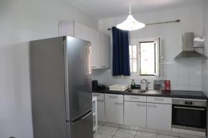 a kitchen with a stainless steel refrigerator and a sink at Galini Home 2 in Prokópion