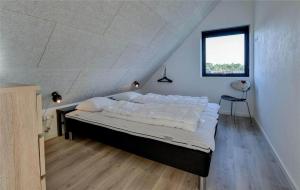 a bedroom with a large bed in a attic at 0374-Romo-Vestergade-337 in Høm