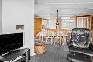 a kitchen and dining room with a table and chairs at 0225-Romo-Kromosevej-22-A in Høm