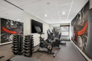 a gym with cardio equipment and posters on the walls at Best Western Plus Gilbert/Mesa in Mesa