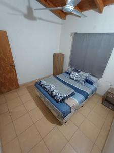 a bed sitting in a room with a ceiling at Cabaña Doña Adela II in Paso de la Patria