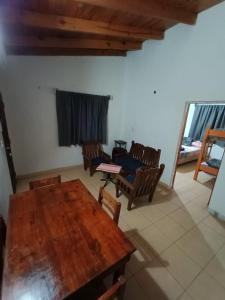a living room with a wooden table and chairs at Cabaña Doña Adela II in Paso de la Patria