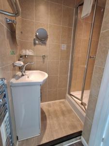 a bathroom with a sink and a shower at The Florian in Weymouth +27 photos