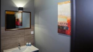 a bathroom with a sink and a mirror at Maiers Hotel in Bayerisch Eisenstein