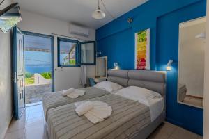 a bedroom with a bed with a blue wall at Metaxatos Apartments in Lassi +251 photos