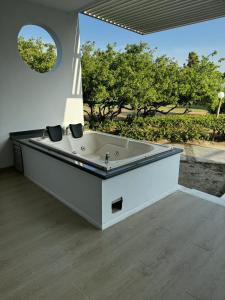a large bath tub in a room with trees at 31 Exclusive Cabin with Private Jacuzzi, Beach in Tubará