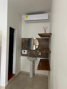 a bathroom with a sink and a mirror at Hotel Boutique Primavera Beach in Necoclí +57 photos