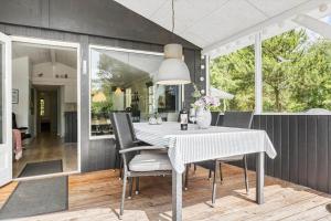 a dining room with a table and chairs at 2801-Romo-Helmusager-4 in Høm +15 photos