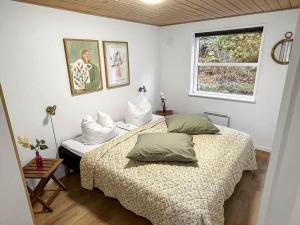 a bedroom with two beds and a window at 2801-Romo-Helmusager-4 in Høm