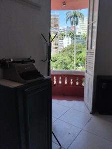 a room with a window with a view of a city at Estalagem Triplex Vermelho in Vitória