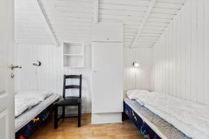 a room with a bed and a chair in it at 0386-Romo-Vestergade-3-Ap-16 in Høm
