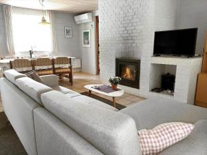 a living room with a couch and a fireplace at 0357-Romo-Sonderstrandvej-21 in Høm