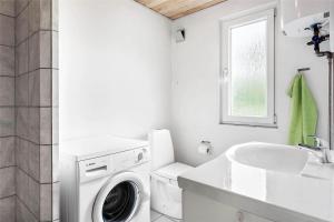 a white laundry room with a washing machine and a sink at 0357-Romo-Sonderstrandvej-21 in Høm +16 photos