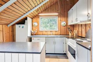 a kitchen with white appliances and a wooden ceiling at 0146-Romo-Ejnar-Mikkelsensvej-16 in Høm +10 photos