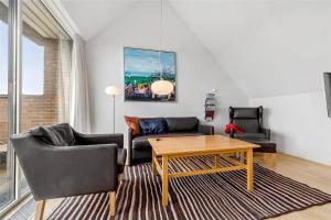 a living room with a couch and chairs and a table at 1356-Romo-Blaklokkevej-356 in Høm