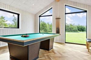 a pool table in a room with large windows at 0346-Romo-Vestergardsvaenget-11 in Høm