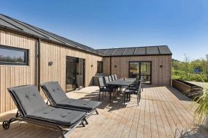 a patio with chairs and a table on a deck at 0346-Romo-Vestergardsvaenget-11 in Høm