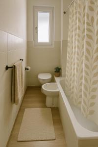 a bathroom with a toilet and a shower curtain at Brunate Funicolare Apartament in Brunate +26 photos