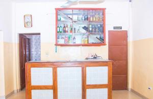 a kitchen with a sink and a medicine cabinet at Hotel Résidence Les Racines in Pira