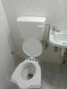 a bathroom with a white toilet and a sink at relax in Shimla