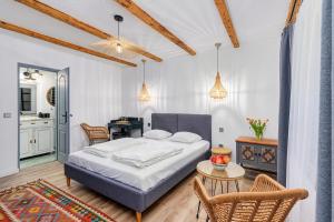a bedroom with a bed and a table and chairs at Káli Kert Vendégház in Szentbékkálla