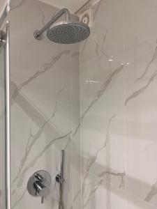 a shower with a glass door with a shower head at Hely's House in Naples +46 photos