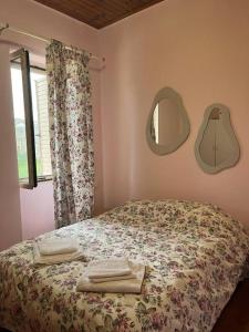 a bedroom with a bed and a mirror on the wall at Αιθεροβάμων - Etherovamon in Areopoli