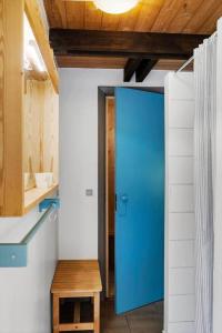 a blue door in a room with a wooden ceiling at 0337-Romo-Kliren-1 in Høm +36 photos