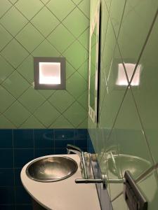 a bathroom with a sink and a mirror at COliving RD6 in Ljubljana