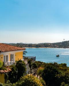 a house with a view of a body of water at Uni Boutique Hotel & Spa in Búzios +75 photos
