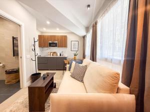 a living room with a couch and a kitchen at Studios Mugakoa By Sahats in Portugalete