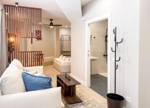 a living room with a white couch and a bathroom at Studios Mugakoa By Sahats in Portugalete +87 photos
