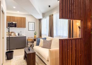 a living room with a couch and a kitchen at Studios Mugakoa By Sahats in Portugalete