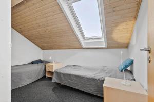 two beds in a room with a window at 0353-Romo-Vestergade-155-B-Ap-130 in Høm +25 photos