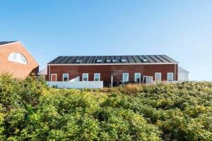 a house with solar panels on top of a hill at 0353-Romo-Vestergade-155-B-Ap-130 in Høm