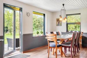 a dining room with a table and chairs at 0187-Romo-Egedesminde-1 in Høm