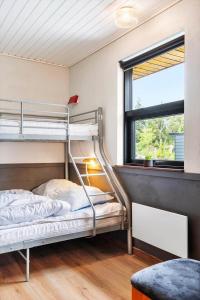a bedroom with two bunk beds and a window at 0187-Romo-Egedesminde-1 in Høm