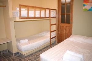 two bunk beds in a room with two white beds at Punta Sal Bungalows in Canoas de Punta Sal +42 photos